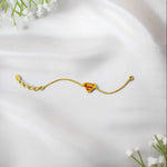 Gold bracelet with a red 'S' superman